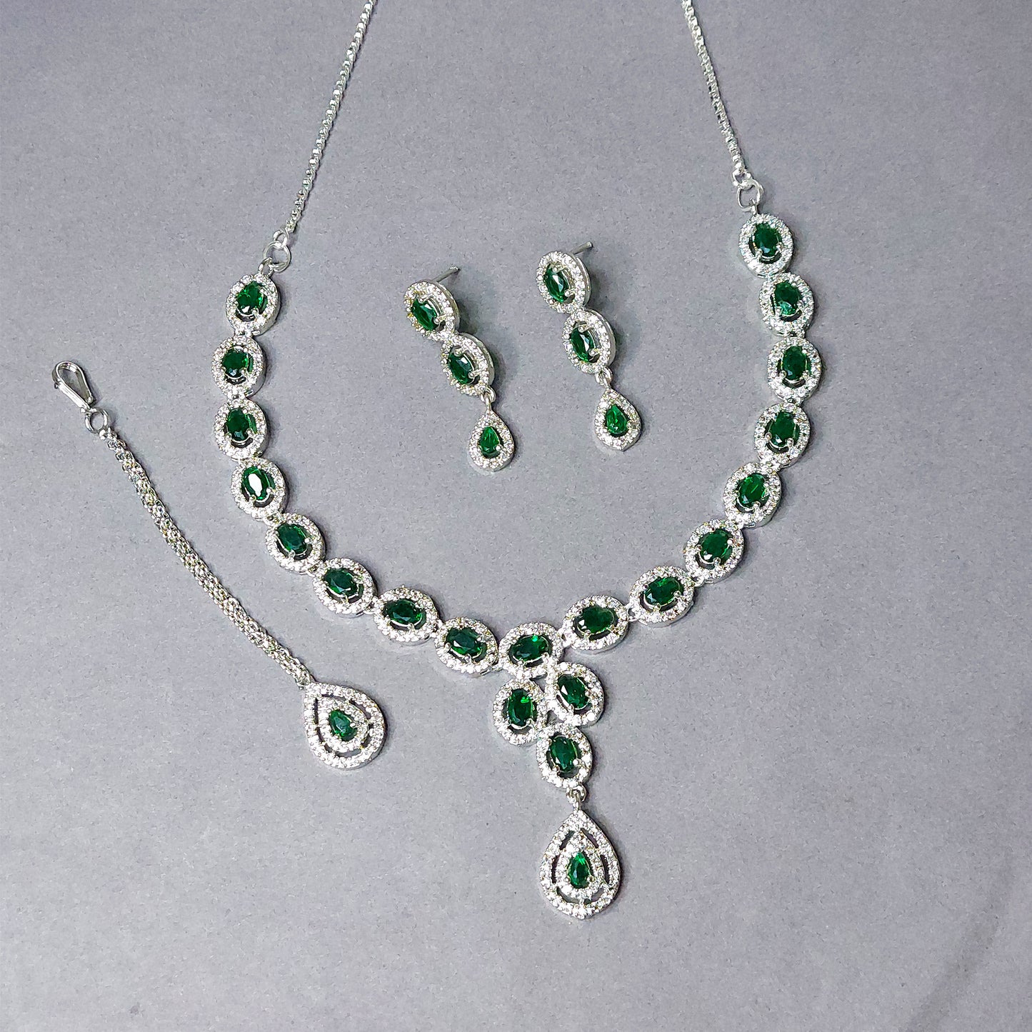 Rhodium Plated Silver Toned Emerald Green American Diamond Studded Necklace with Earring Jewellery Set with Maang Tikka